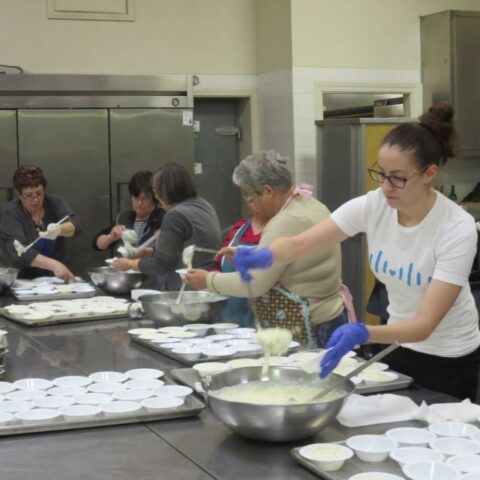 volunteers baking pastries for fundraiser